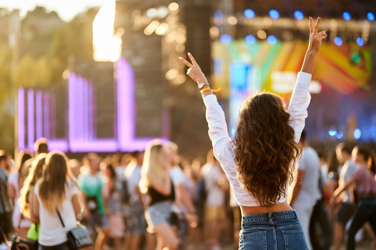 a woman enjoys music at a festival