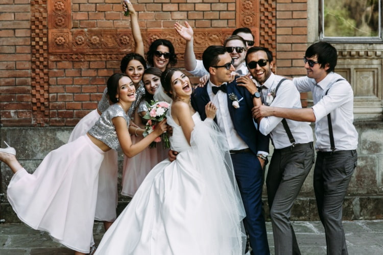 a candid photo of the bride and groom with their wedding party