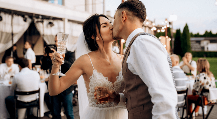 a married couple kisses