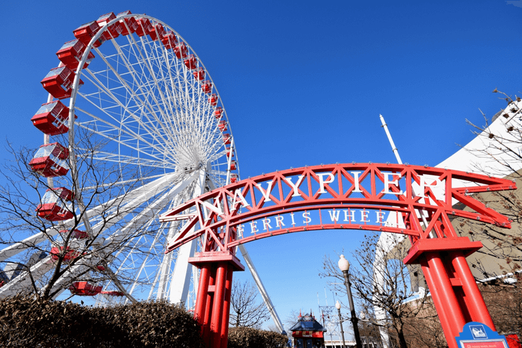 a view of the navy pier sign and ferris wheel